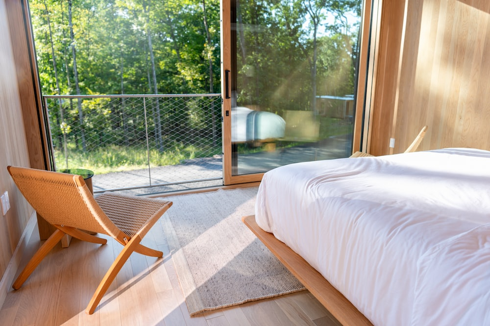 A room with a minimal interior design and glass door